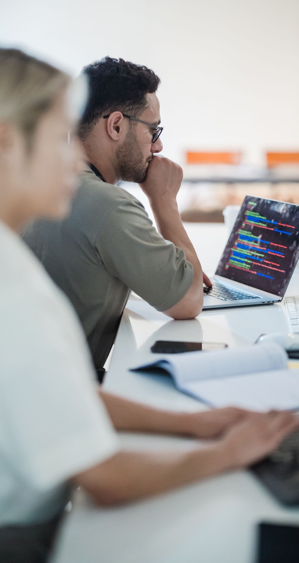 Software engineers reviewing code together
